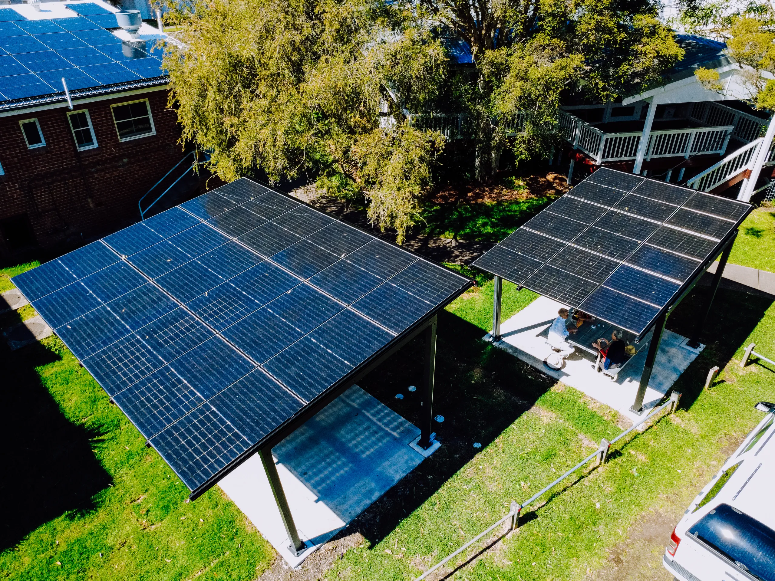 Residential solar carports over a backyard, aerial view