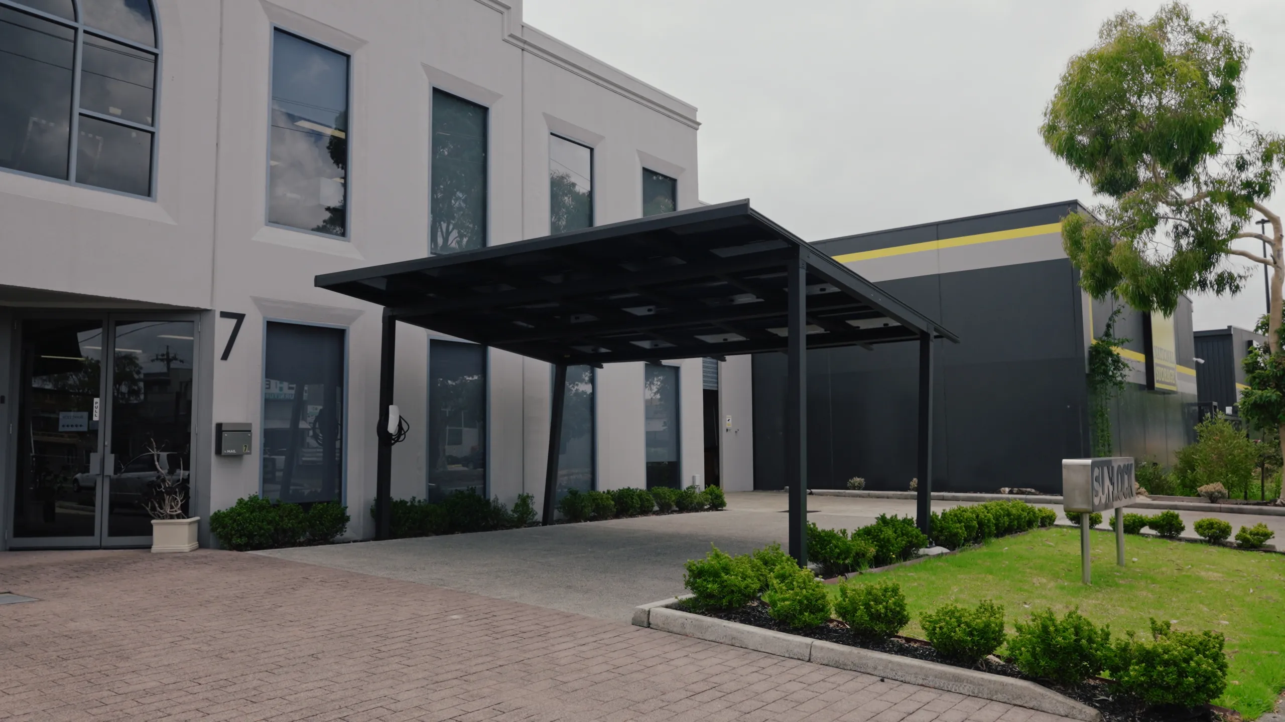 Commercial solar carport canopy at a business entrance